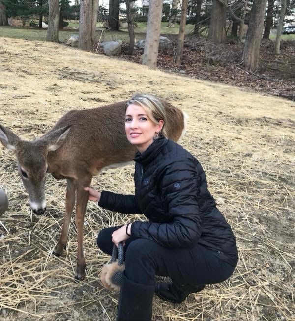 A picture of Dr. James with a deer outside